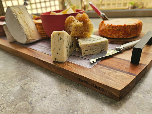 Wooden cheese board with assorted cheeses