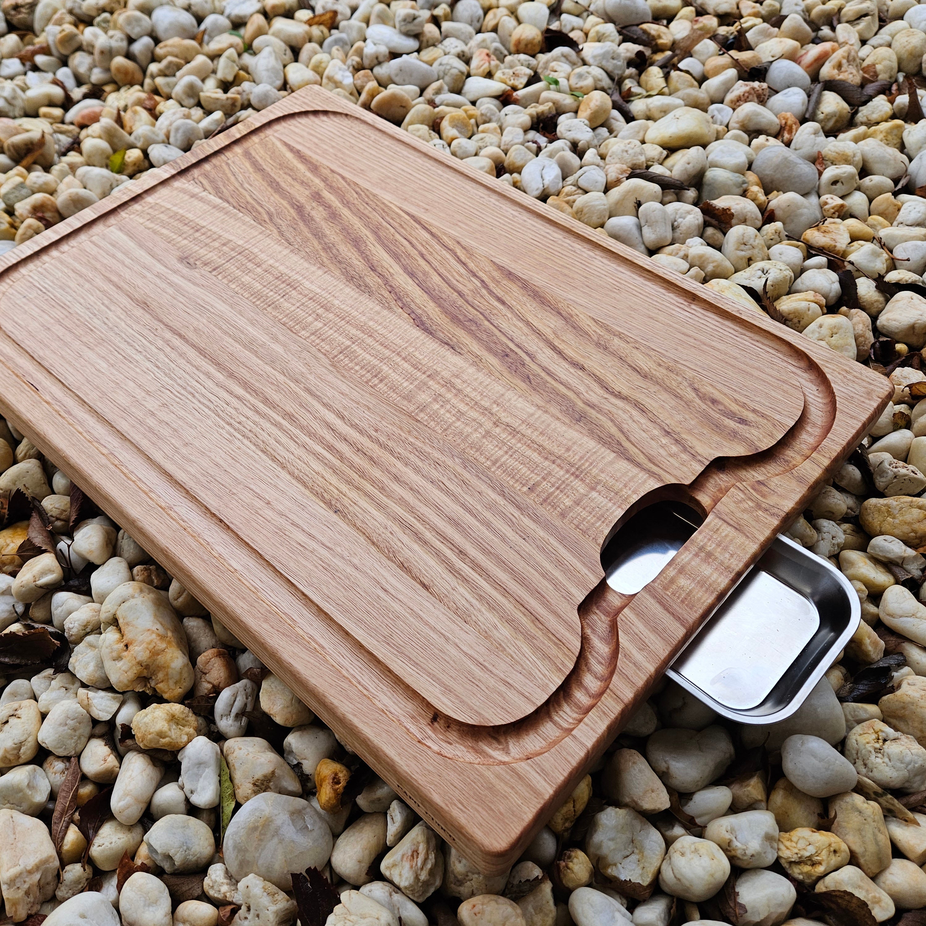 Wooden cutting board with a juice tray